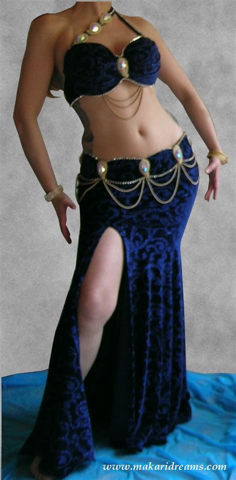 A Woman In A Blue And Black Belly Dance Costume Posing For The Camera