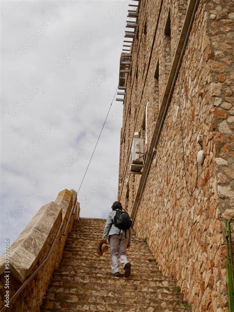 Woman Walking Up Steep Stairs In Ayna Charming Mountain Village In The