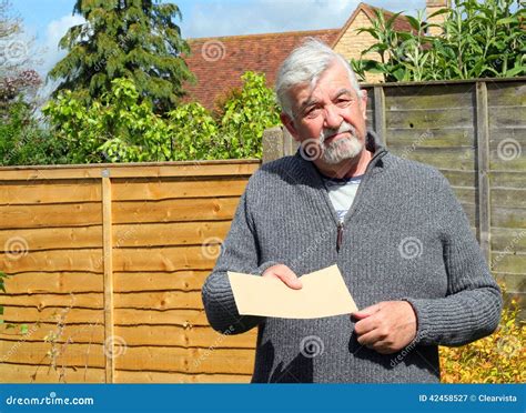 Senior Man Giving A Plain Brown Envelope Stock Image Image Of Giving