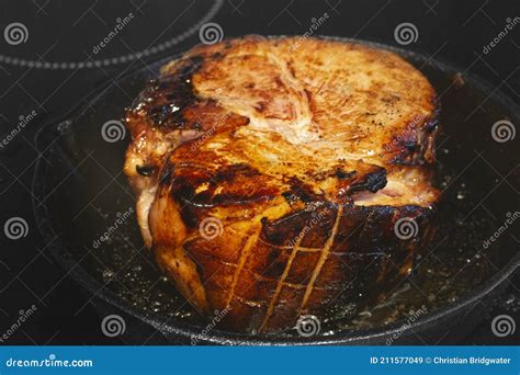 Searing A Glazed Gammon Ham Joint Of Meat Cast Iron Frying Pan On A