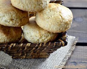 A Basket Full Of Biscuits Sitting On Top Of A Wooden Table