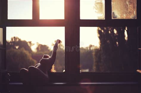 Beautiful Naked Female Sitting On A Window At Sunset Stock Photo Image Of Large Pitch