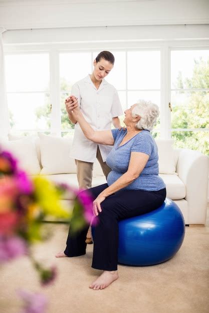 Premium Photo Physiotherapist Taking Care Of Sick Elderly Patient At Home