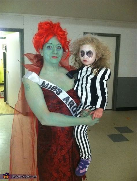 Two People Dressed Up In Costumes And Makeup Posing For The Camera With