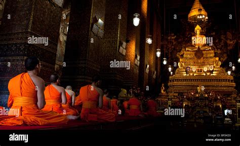 Monks Sit Chanting In Temple With Golden Seated Buddha Wat Pho