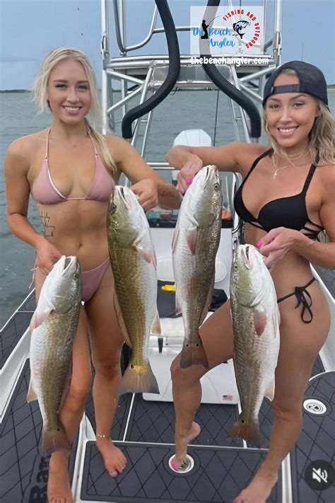 A Couple Of Bikini Clad Lady Fisherman Each Holding Up Two Upper Slot