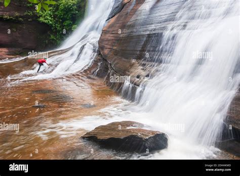 Happy An Asian Boy Playing In Freshwater Of Tropical Waterfall In