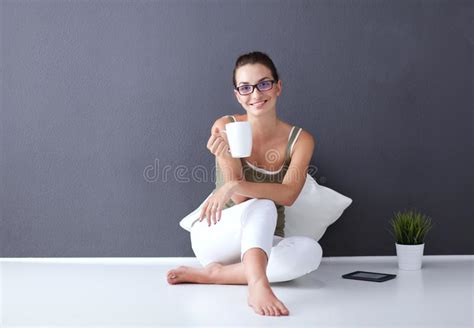 Attractive Caucasian Girl Sitting On Floor With Cup And Tablet Near