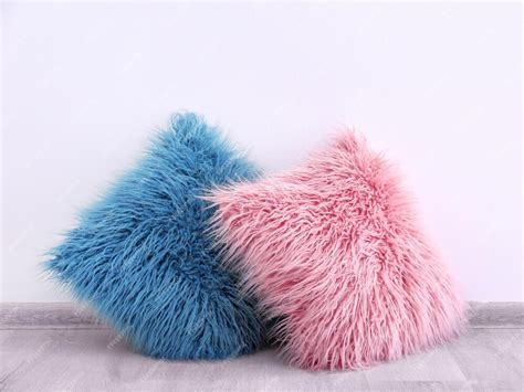 Premium Photo Two Fluffy Pillows On Wooden Floor Near Wall