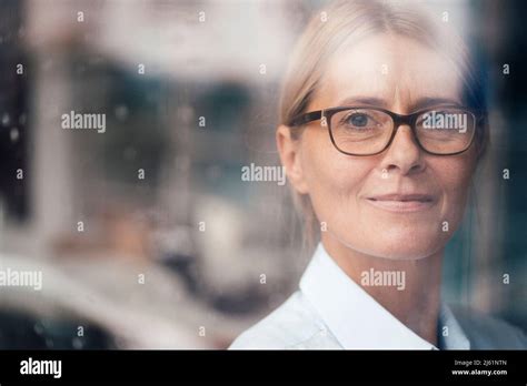 Contemplative Mature Woman Seen Through Glass Stock Photo Alamy