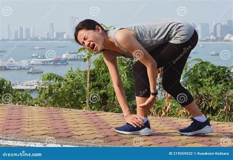 Running Woman Screaming In Pain During Running Training Stock Photo