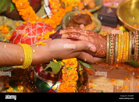 An Indian Bride And Groom Holding Their Hands During A Hindu Wedding