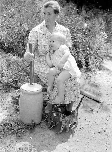 An Appalachian Woman Churning Butter While Carrying On A Conversation