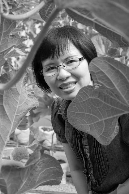 Premium Photo Portrait Of Mature Woman Smiling While Standing Amidst Leaves