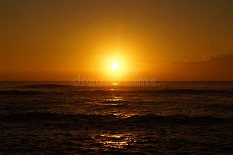 Sunrise Over The Ocean With Waves Rolling Toward Shore Stock Photo - Image: 52205476