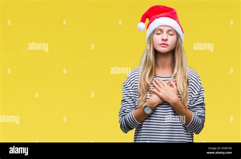 Young Beautiful Blonde Woman Wearing Christmas Hat Over Isolated