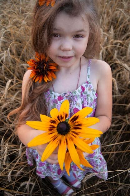 Premium Photo High Angle Portrait Of Cute Girl Holding Yellow Flower