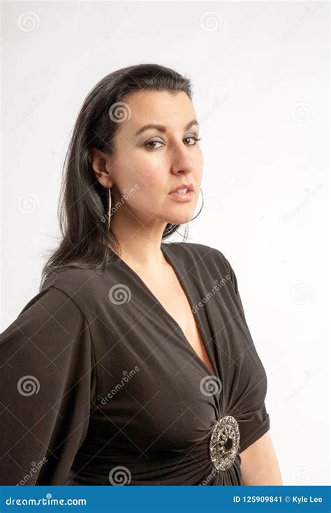 40 Something Brunette Woman In The Studio With A White Background Stock