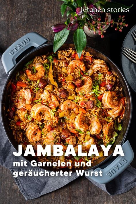 A Skillet Filled With Shrimp And Rice On Top Of A Wooden Table Next To