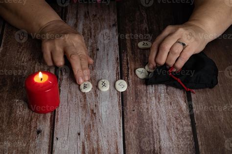 Womans Hands Teaching Rune Stones With Black Symbols For Fortune