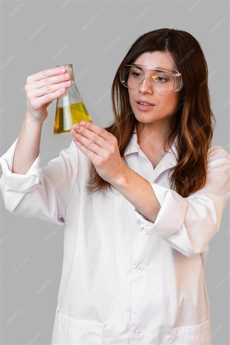 Free Photo Front View Of Female Chemist With Safety Glasses Holding Test Tube