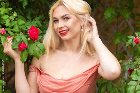 Beautiful Woman With Long Blonde Hair And Red Lips Wearing Pink Clothes Stock Photo Adobe Stock