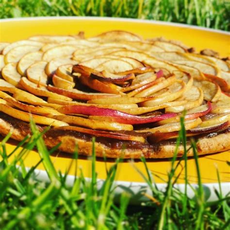 An Apple Pie On A Yellow Plate In The Grass