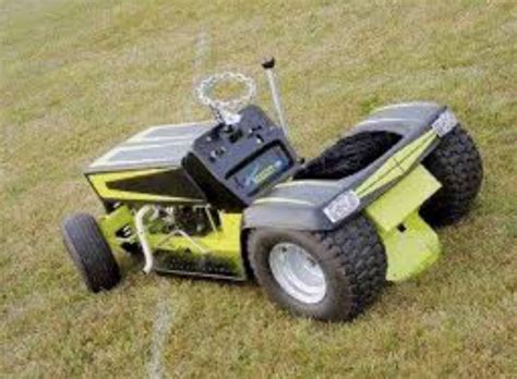 A Lawn Mower Sitting In The Middle Of A Field With No Wheels On It