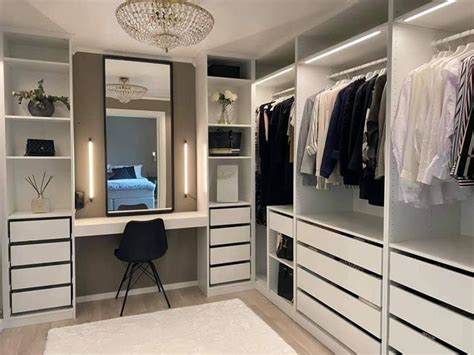 An Organized Closet With White Drawers And Black Accents Including A