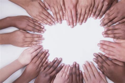 Premium Photo | Multicultural hands on a white backdrop in a heart shape