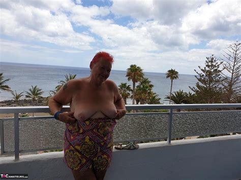 Obese Nan With Spiky Red Hair Unveils Her Tits On Balcony Before Posing