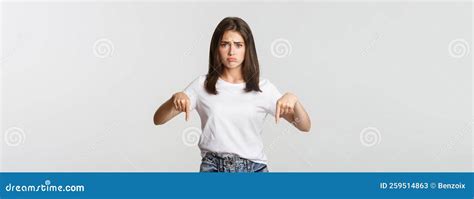 Sad And Gloomy Brunette Girl Sulking Pointing Fingers Down With Regret