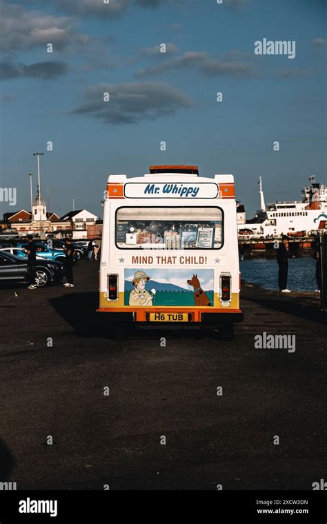 Rear View Of A Colorful Mr Whippy Ice Cream Van Parked Near A Harbor