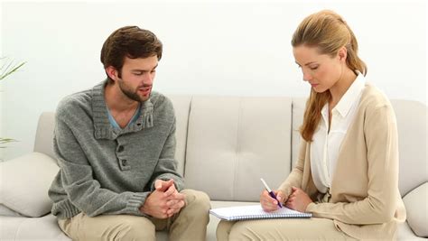 Patient Talking To Her Therapist Who Is Taking Notes And Listening