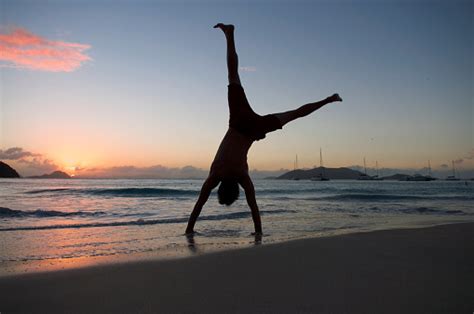 Silhouette Of Man Doing Cartwheel On Sunset Beach Stock Photo ...