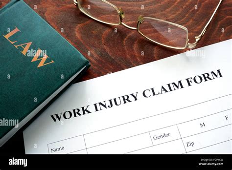 Work Injury Claim Form On A Wooden Table Stock Photo Alamy