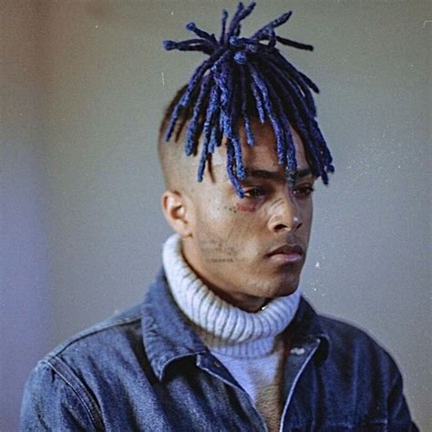 a man with blue dreadlocks on his head