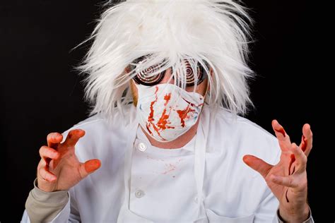 Crazy,Doctor,With,A,Surgeon,Mask,And,Scrubs,Splattered,With - Knee