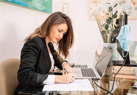 Premium Photo Concentrated Woman Doing Paperwork In Home Office