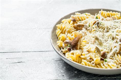 Premium Photo Fusilli Pasta With Mushrooms And Cheese