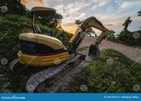 The Modern Excavator On The Construction Site With Sunset Sky Large