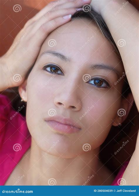 Tight Portrait Of Asian American Woman With Hands On Head Stock Image