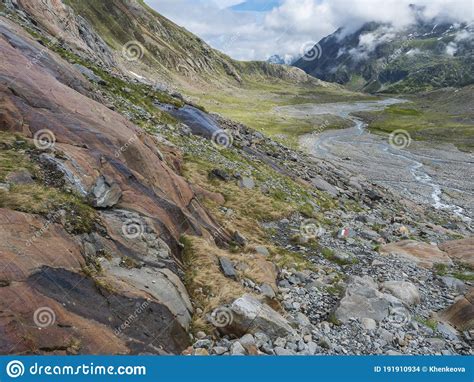 Summer View Of Alpine Mountain Valley With Winding Stream And Glacial