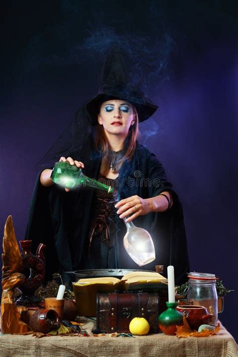 Halloween Witch Cooking A Potion In A Cauldron Stock Photo Image Of