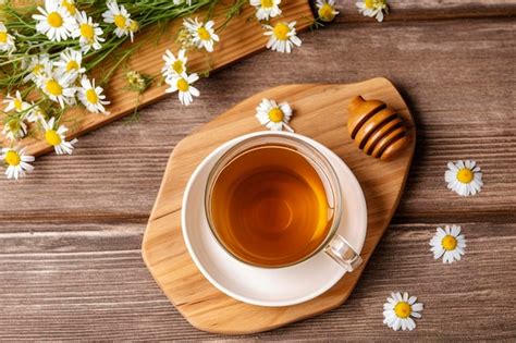 Premium Ai Image Cup Of Hot Chamomile Tea On Light Wooden Background Generative Ai