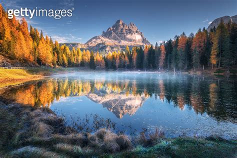 Lake With Reflection Of Mountains At Sunrise In Autumn In Dolomites