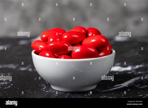 Chocolate Almond Dragee Red Chocolate Dragee In Ceramic Bowl On Dark