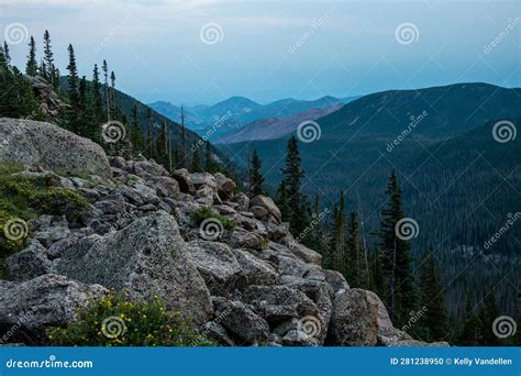 Granite Boulder Field Spills Over Cliff Into Forested Valley Below