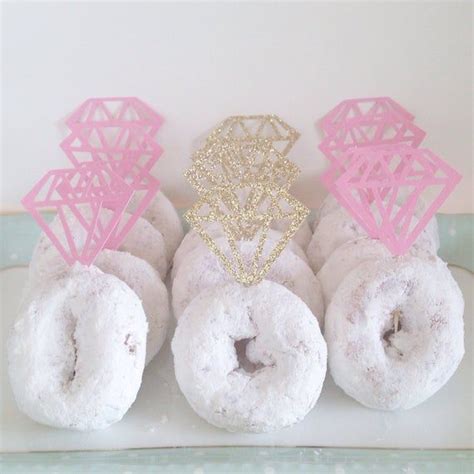 There Are Four Donuts With Pink Frosting On The Top And One Is White