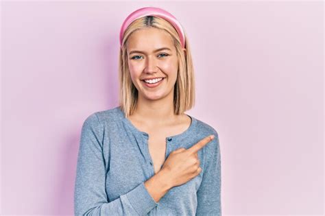 Premium Photo Beautiful Blonde Woman Standing Over Pink Background